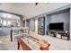 Open-concept living and dining area, featuring a large TV and a modern entertainment center at 9065 Adorable Ave, Las Vegas, NV 89149
