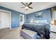 Serene main bedroom with blue walls, neutral carpet, ceiling fan, and natural light at 9065 Adorable Ave, Las Vegas, NV 89149