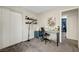 A home office has beige carpet, white walls, and a small work area at 9065 Adorable Ave, Las Vegas, NV 89149