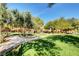Lush park with trees, green grass, a playground, and a picnic area on a sunny day at 9065 Adorable Ave, Las Vegas, NV 89149