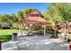 Community picnic area featuring tables, a covered gazebo, landscaping, and nearby trees at 9065 Adorable Ave, Las Vegas, NV 89149