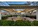 Outdoor picnic area with multiple tables under a covered gazebo surrounded by green hedges at 9065 Adorable Ave, Las Vegas, NV 89149