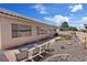 Relaxing backyard featuring a cozy patio, various seating areas, and drought-resistant landscaping at 9096 Nomo St, Las Vegas, NV 89123