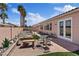 Charming backyard showcasing a brick patio, lush landscaping, and inviting seating areas at 9096 Nomo St, Las Vegas, NV 89123