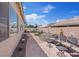 Private backyard retreat with multiple seating areas and lush, low-maintenance landscaping at 9096 Nomo St, Las Vegas, NV 89123