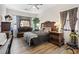 A serene bedroom with hardwood floors, a dresser, and natural light at 9096 Nomo St, Las Vegas, NV 89123