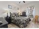 Comfortable bedroom featuring a ceiling fan, a window and a queen bed with a patterned comforter set at 9096 Nomo St, Las Vegas, NV 89123