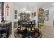 Elegant dining room with a round table, exquisite black chairs, and a showcase cabinet filled with decorative items at 9096 Nomo St, Las Vegas, NV 89123