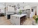 A well-lit kitchen with marble counters, stainless appliances, and barstool seating at 9096 Nomo St, Las Vegas, NV 89123