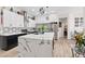 A modern kitchen features a marble island, stainless appliances, and white cabinets at 9096 Nomo St, Las Vegas, NV 89123