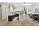 Bright kitchen featuring a marble island, modern cabinets, and an open living area at 9096 Nomo St, Las Vegas, NV 89123