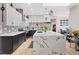 The kitchen features sleek white cabinets, a marble island, and modern backsplash at 9096 Nomo St, Las Vegas, NV 89123