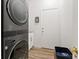 Laundry area with a full-sized washer and dryer, white cabinets and access to the exterior at 9096 Nomo St, Las Vegas, NV 89123