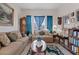 Comfortable living room with classic decor, including patterned sofas, a decorative rug, and ample natural light at 9096 Nomo St, Las Vegas, NV 89123