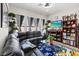 Comfortable living room with a leather sectional sofa, a blue patterned rug and backyard views at 9096 Nomo St, Las Vegas, NV 89123