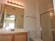 Bathroom featuring vanity and updated shower with glass doors and bright vanity lighting at 9470 Peace Way # 112, Las Vegas, NV 89147