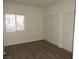 Bedroom with laminate wood floors and a window for natural light at 9470 Peace Way # 112, Las Vegas, NV 89147