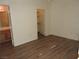 Comfortable bedroom with wood-look floors, light walls, and closet access at 9470 Peace Way # 112, Las Vegas, NV 89147