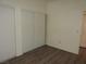 Bedroom with wood floors, white walls, and sliding closet doors at 9470 Peace Way # 112, Las Vegas, NV 89147