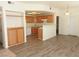 Open-concept living room with bar counter looking into the kitchen and wood floors at 9470 Peace Way # 112, Las Vegas, NV 89147