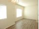 Bright and airy living room featuring two windows and laminate floors at 9470 Peace Way # 112, Las Vegas, NV 89147
