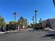 Street view of the community lined with palm trees at 9470 Peace Way # 112, Las Vegas, NV 89147