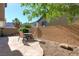 Cozy backyard featuring a stone patio with outdoor seating and a block wall for added privacy at 9780 Ziegler Ave, Las Vegas, NV 89148