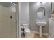 Bathroom featuring a glass-enclosed shower, toilet, and pedestal sink, with neutral wall color at 9780 Ziegler Ave, Las Vegas, NV 89148
