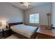 Bright bedroom with a ceiling fan, a window for natural light, and a wooden bed frame at 9780 Ziegler Ave, Las Vegas, NV 89148