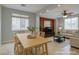 Open-concept living and dining area with tile floors and large windows at 9780 Ziegler Ave, Las Vegas, NV 89148