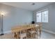 Dining room featuring a large window and an expansive table with six chairs at 9780 Ziegler Ave, Las Vegas, NV 89148