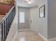 Inviting entryway with neutral paint, tiled floor, and staircase access to the upper level at 9780 Ziegler Ave, Las Vegas, NV 89148