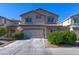 Two-story home with two-car garage and landscaped front yard at 9780 Ziegler Ave, Las Vegas, NV 89148