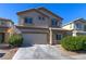Front exterior of a two-story home with a two-car garage at 9780 Ziegler Ave, Las Vegas, NV 89148
