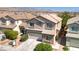 Charming two-story home with a well-maintained lawn and desert landscaping in a suburban neighborhood at 9780 Ziegler Ave, Las Vegas, NV 89148