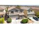 Pleasant two-story home with an attached two-car garage and easy to maintain front yard landscaping at 9780 Ziegler Ave, Las Vegas, NV 89148