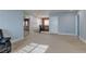 Hallway showcasing multiple doorways and openings, neutral carpet, and stylish lighting fixtures at 9780 Ziegler Ave, Las Vegas, NV 89148
