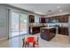 Modern kitchen with dark cabinets, granite countertops, stainless steel appliances, and a sliding glass door at 9780 Ziegler Ave, Las Vegas, NV 89148