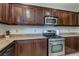 Kitchen with granite countertops, stainless steel appliances, and dark cabinets at 9780 Ziegler Ave, Las Vegas, NV 89148
