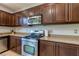 Well-equipped kitchen featuring stainless steel appliances, granite countertops, and dark wood cabinets at 9780 Ziegler Ave, Las Vegas, NV 89148