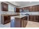 Kitchen features granite countertops, stainless steel appliances, and dark wood cabinets at 9780 Ziegler Ave, Las Vegas, NV 89148