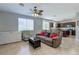 Cozy living room with an adjacent kitchen, tile floors, and a decorative ceiling fan at 9780 Ziegler Ave, Las Vegas, NV 89148
