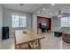 Open-concept living room and dining area with natural light, tiled floor, and a ceiling fan at 9780 Ziegler Ave, Las Vegas, NV 89148