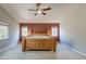 Main bedroom featuring a large wooden bed, carpeting, and a neutral accent wall at 9780 Ziegler Ave, Las Vegas, NV 89148