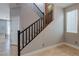 Carpeted staircase with dark railing leading to the upper level of the home at 9780 Ziegler Ave, Las Vegas, NV 89148