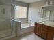 Bathroom featuring double sinks, a soaking tub, and a separate glass-enclosed shower at , Las Vegas, NV 89148