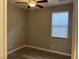 A simple bedroom with hardwood floors, a ceiling fan, and a window for natural light at , Las Vegas, NV 89148