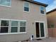 Exterior view of the home featuring multiple windows and a sliding glass door to the patio at , Las Vegas, NV 89148