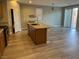 Bright kitchen with island, stainless steel appliances, pendant lighting and vinyl plank flooring at , Las Vegas, NV 89148