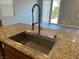 Kitchen island features a granite countertop, a large sink, and a stainless steel faucet at , Las Vegas, NV 89148